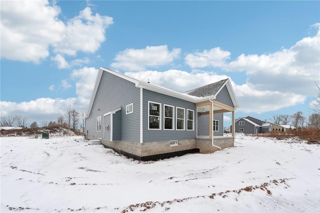 view of snow covered exterior featuring a porch