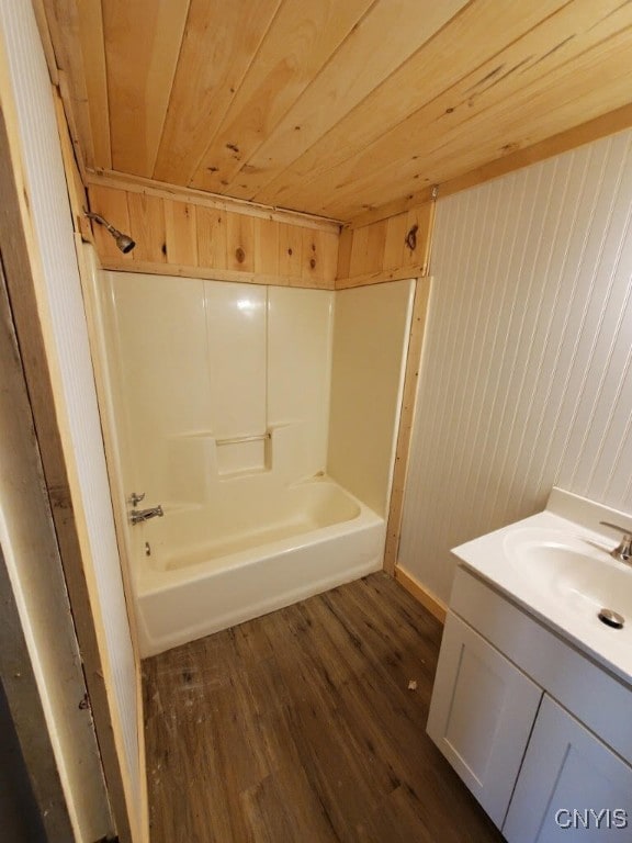 bathroom with hardwood / wood-style floors, wooden ceiling, wood walls, and vanity