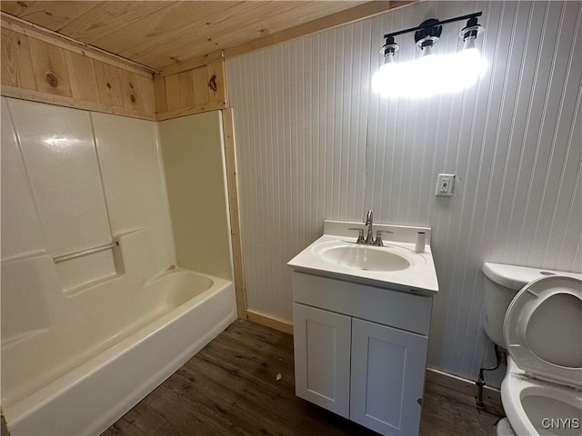 bathroom with wooden ceiling, wood walls, hardwood / wood-style floors, vanity, and toilet