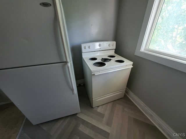 kitchen with white appliances and parquet floors