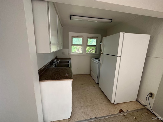 kitchen with white appliances, sink, and white cabinets