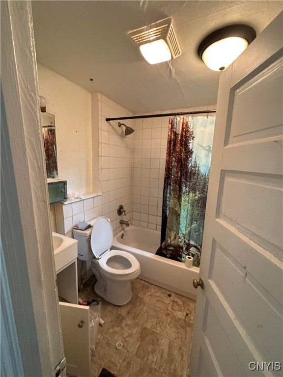 full bathroom featuring vanity, toilet, and shower / tub combo