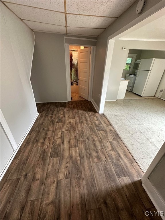 interior space with dark hardwood / wood-style floors and a paneled ceiling