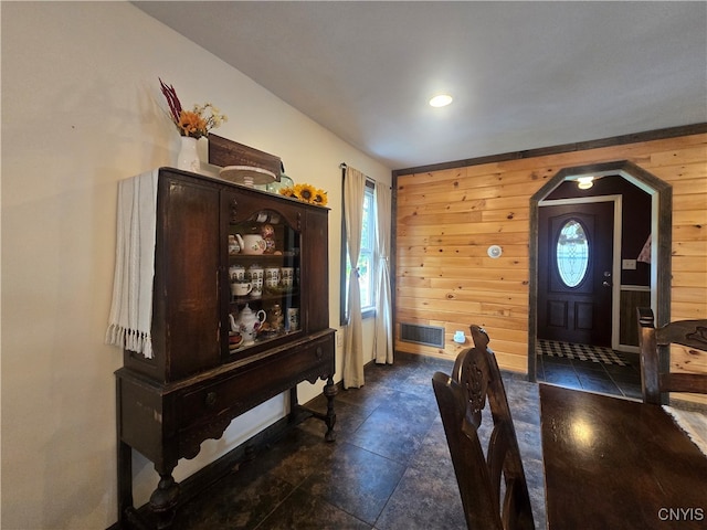 entryway featuring wood walls