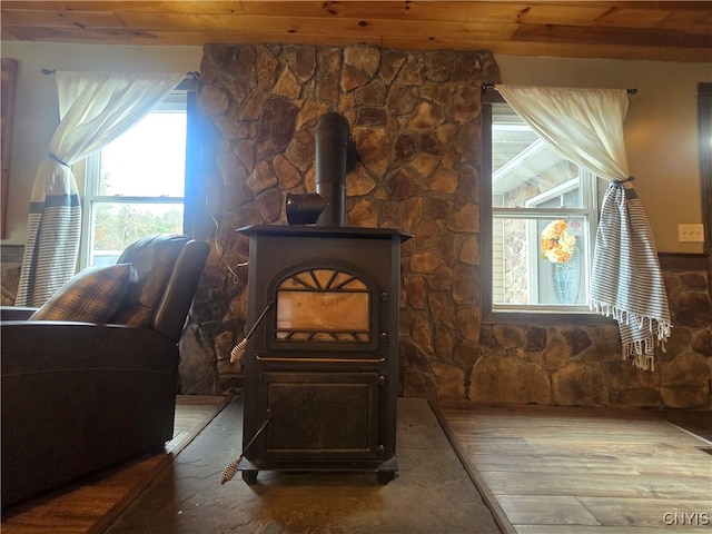 details with hardwood / wood-style floors, wood ceiling, and a wood stove