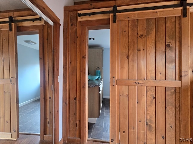 hallway featuring hardwood / wood-style floors and a barn door