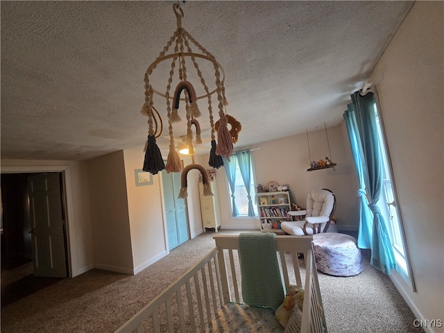 interior space featuring a textured ceiling and carpet floors