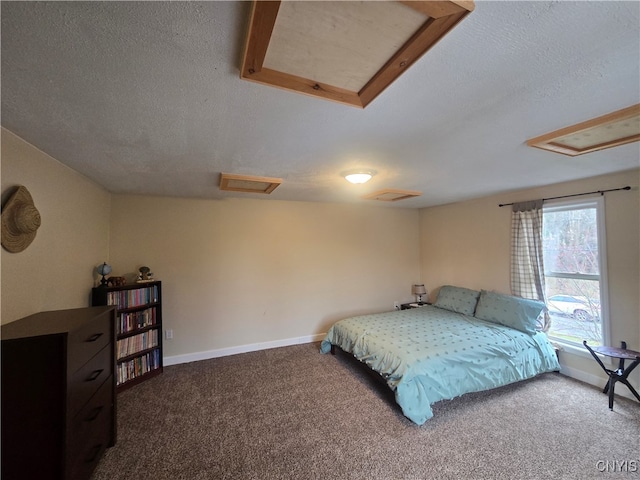 carpeted bedroom with a textured ceiling