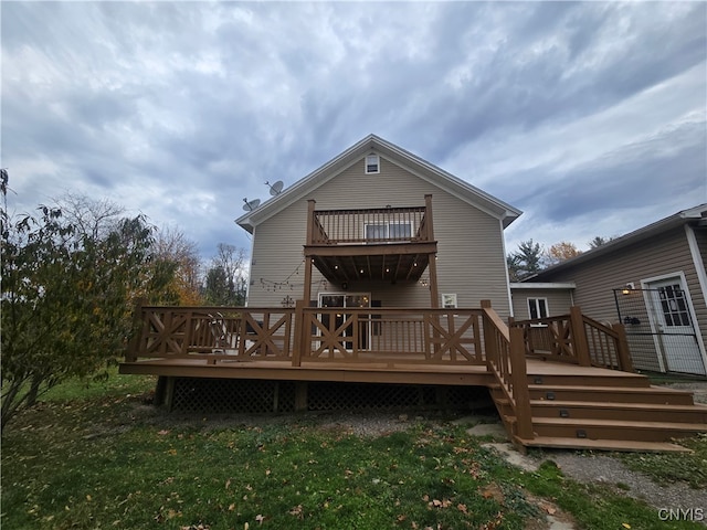 rear view of property with a lawn and a wooden deck