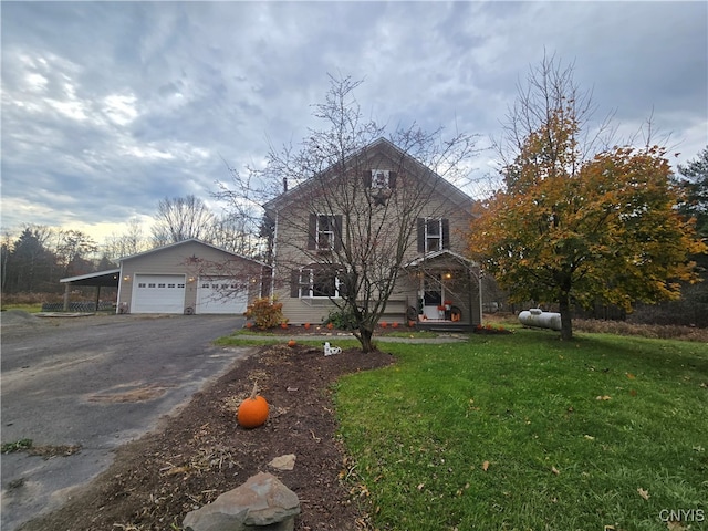 view of property with a front yard, a garage, and an outdoor structure