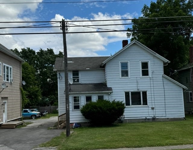 rear view of house with a lawn