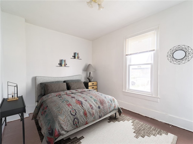 bedroom with dark wood-type flooring