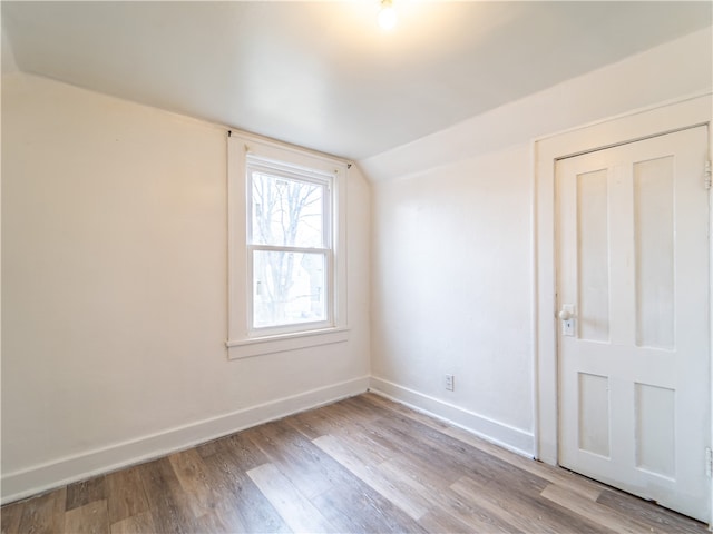 bonus room featuring light hardwood / wood-style floors and lofted ceiling