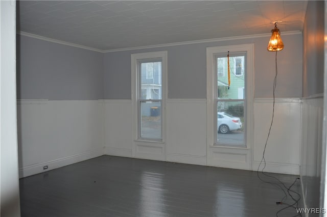 empty room featuring ornamental molding and dark hardwood / wood-style floors