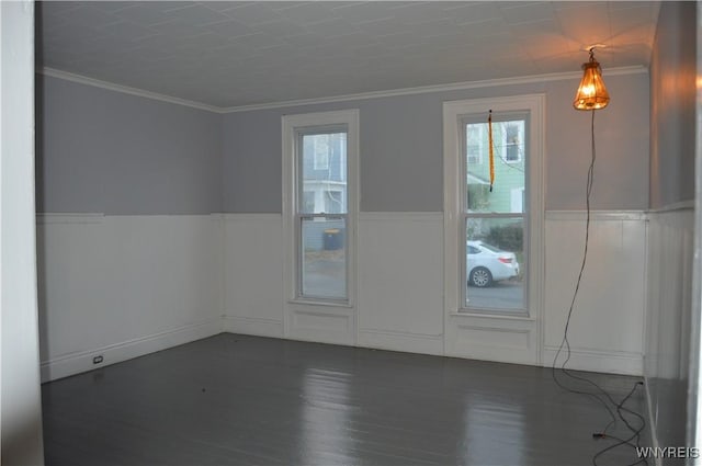 unfurnished room featuring ornamental molding, dark hardwood / wood-style flooring, and a wealth of natural light