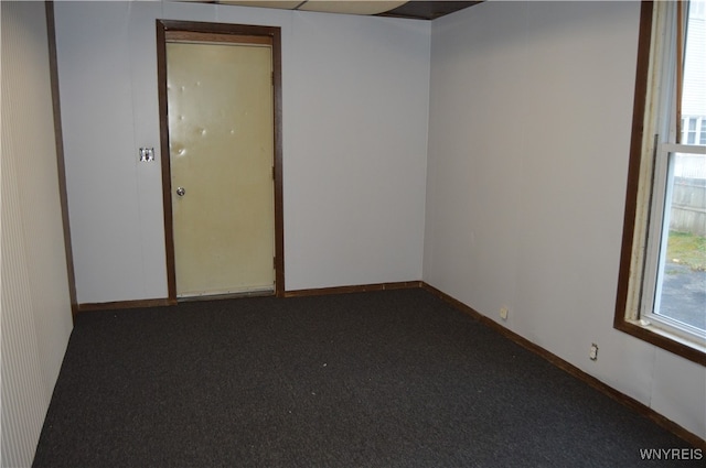 empty room with dark carpet