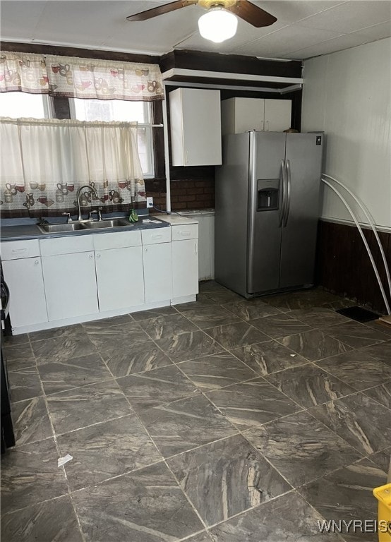 kitchen featuring sink, ceiling fan, white cabinets, and stainless steel refrigerator with ice dispenser