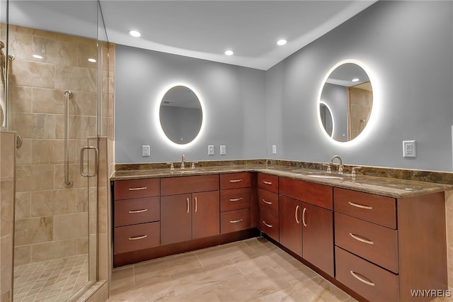 bathroom with an enclosed shower, vanity, and tile patterned flooring