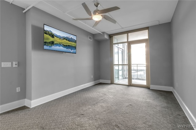 spare room with ceiling fan and carpet