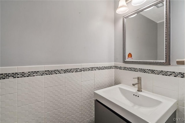 bathroom with vanity and tile walls