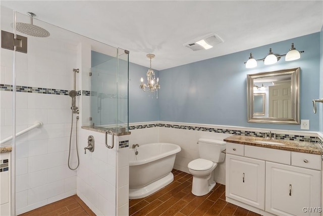 full bathroom featuring vanity, hardwood / wood-style flooring, tile walls, plus walk in shower, and toilet