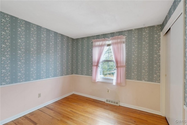 unfurnished room featuring hardwood / wood-style flooring