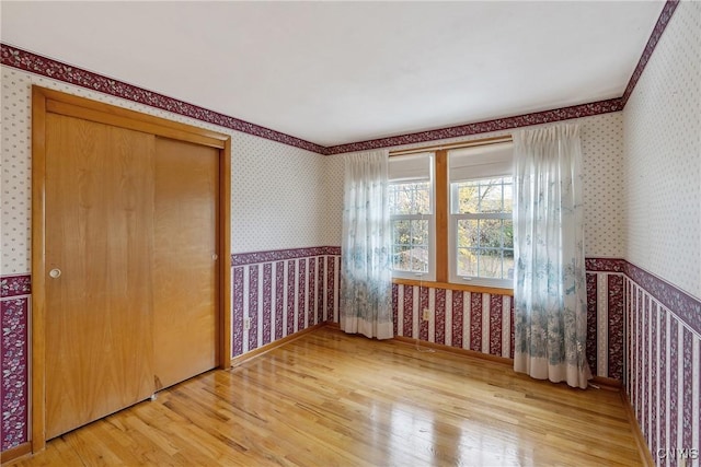 unfurnished bedroom featuring hardwood / wood-style floors and a closet