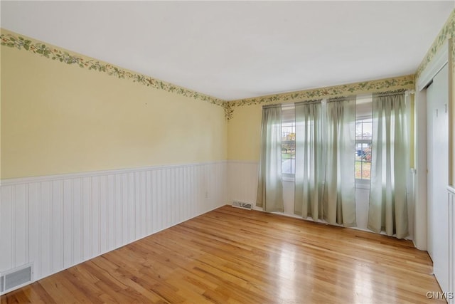 empty room with light hardwood / wood-style flooring