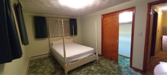 carpeted bedroom with baseboard heating and a closet