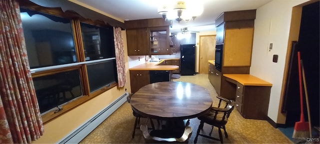 dining space with ceiling fan and a baseboard radiator