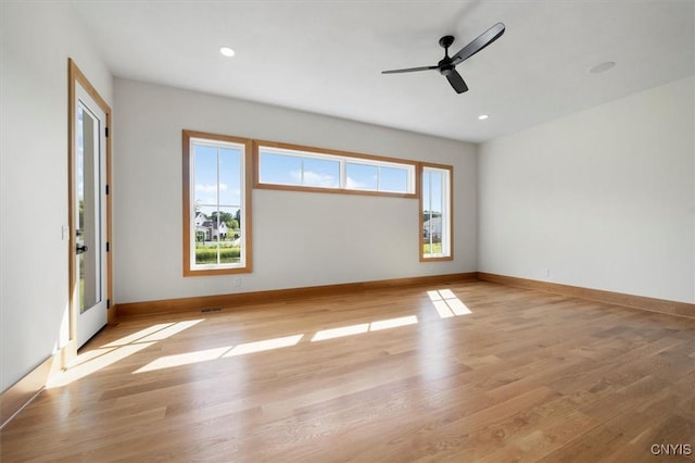 spare room with light hardwood / wood-style floors and ceiling fan