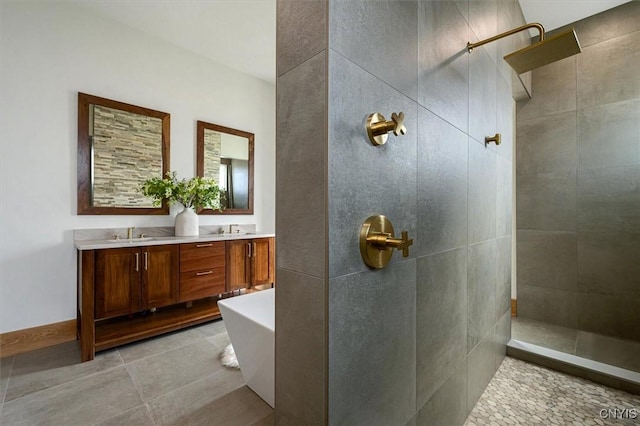 bathroom featuring tile patterned flooring, vanity, and shower with separate bathtub