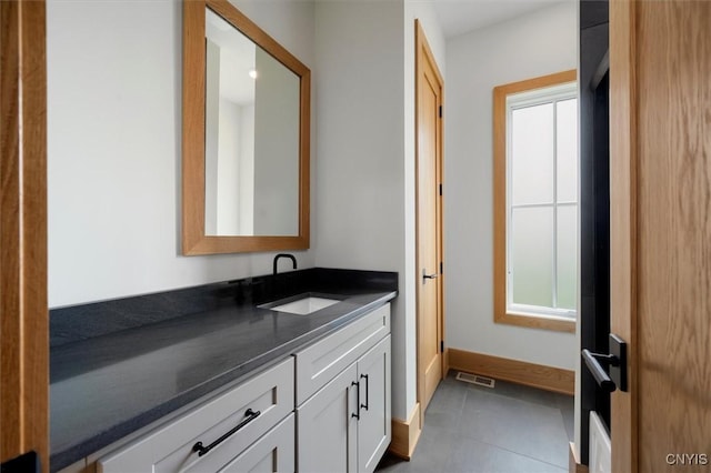 bathroom featuring vanity, tile patterned flooring, and plenty of natural light