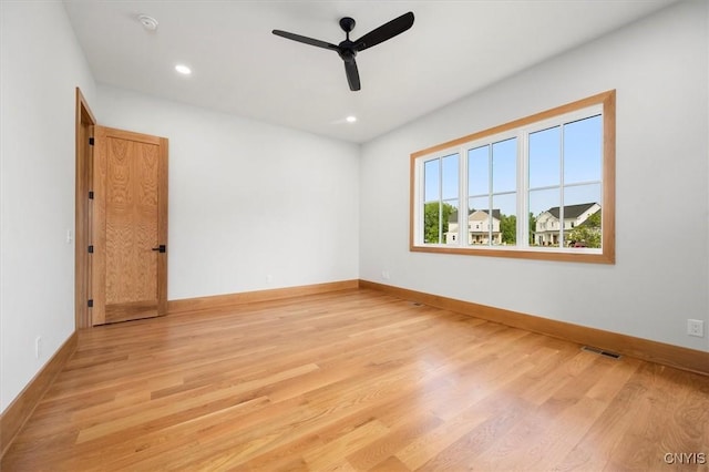 empty room with light wood-type flooring and ceiling fan