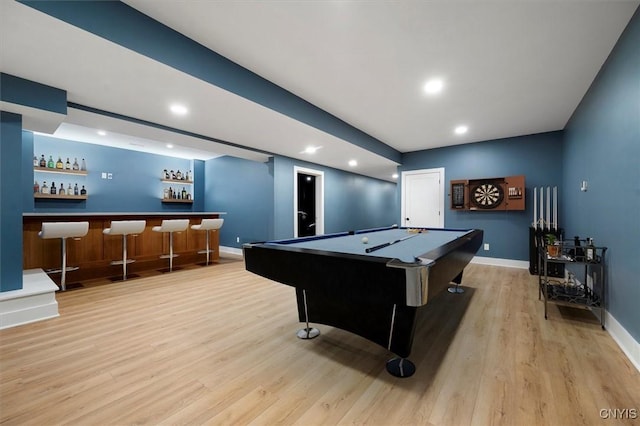 rec room with light hardwood / wood-style floors, indoor bar, and pool table