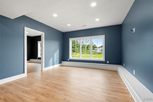 spare room with light hardwood / wood-style flooring