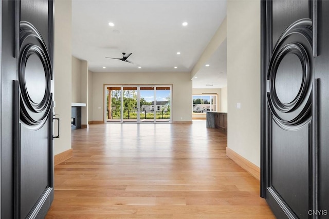 living room featuring ceiling fan and light hardwood / wood-style flooring