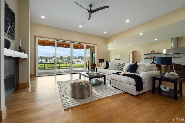 living room featuring ceiling fan and light hardwood / wood-style floors