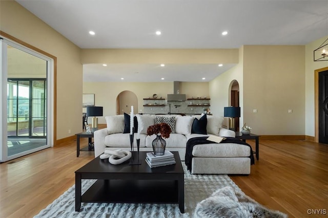 living room featuring a chandelier and light hardwood / wood-style flooring