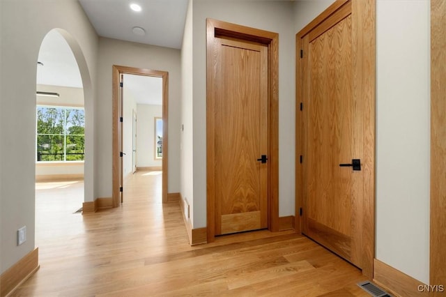 hallway with light hardwood / wood-style floors