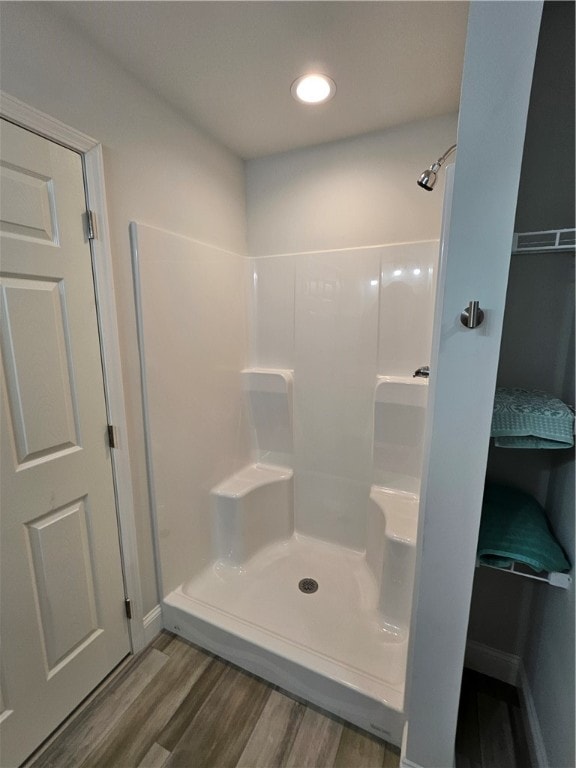 bathroom featuring hardwood / wood-style floors and a shower