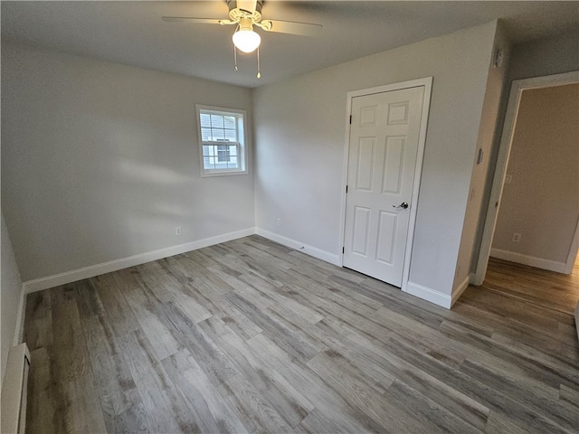 unfurnished bedroom featuring light wood-type flooring and ceiling fan