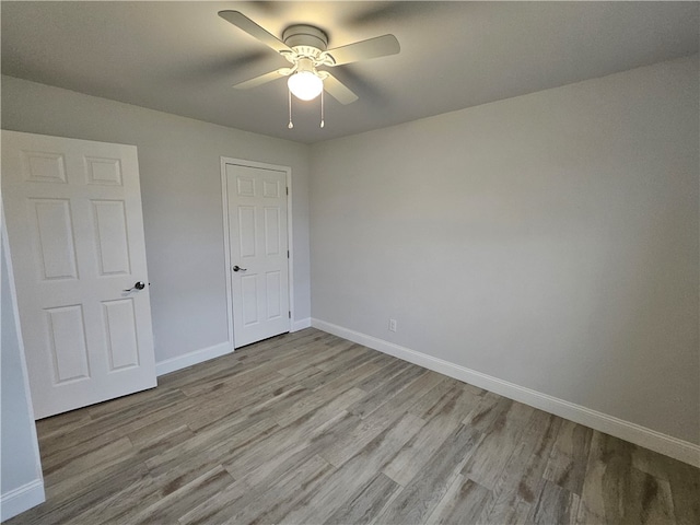 unfurnished bedroom featuring light hardwood / wood-style flooring and ceiling fan