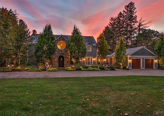 view of front of house featuring a lawn and a garage