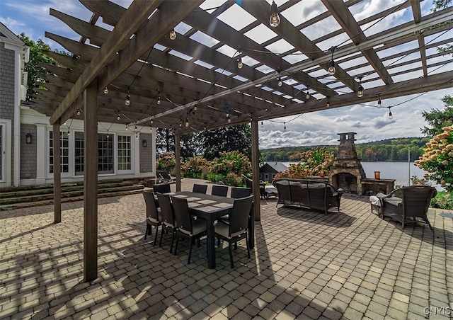 view of patio / terrace with a water view and a pergola