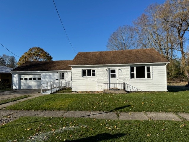 view of front of house featuring a garage and a front lawn