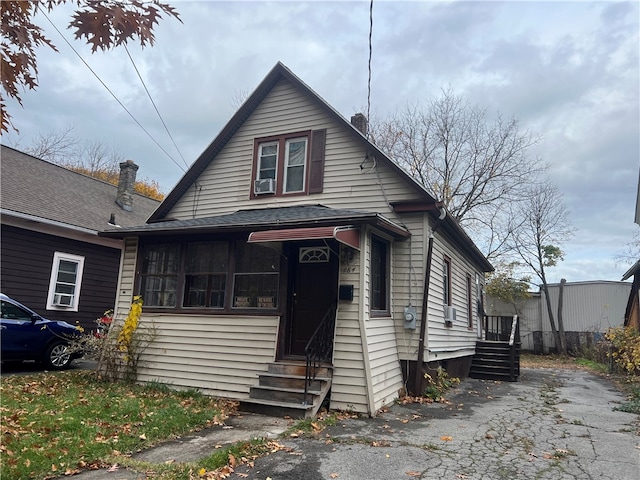 bungalow-style house featuring cooling unit