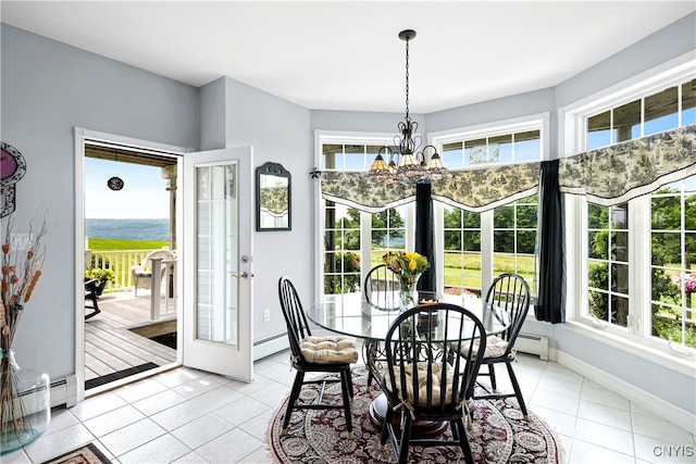 dining space featuring baseboard heating, a healthy amount of sunlight, and light tile patterned floors