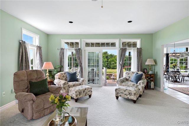 living room featuring an inviting chandelier and light carpet