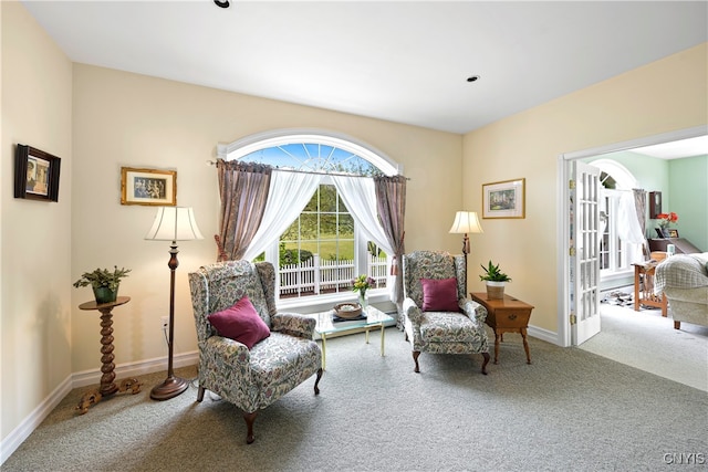 sitting room featuring french doors and carpet floors